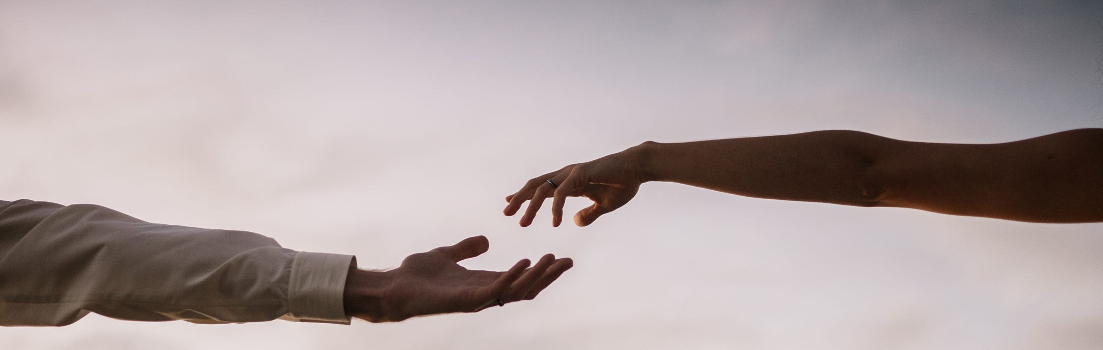 A couple trying to hold hands