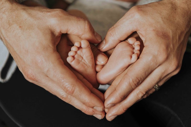 ather baby forming heart shape